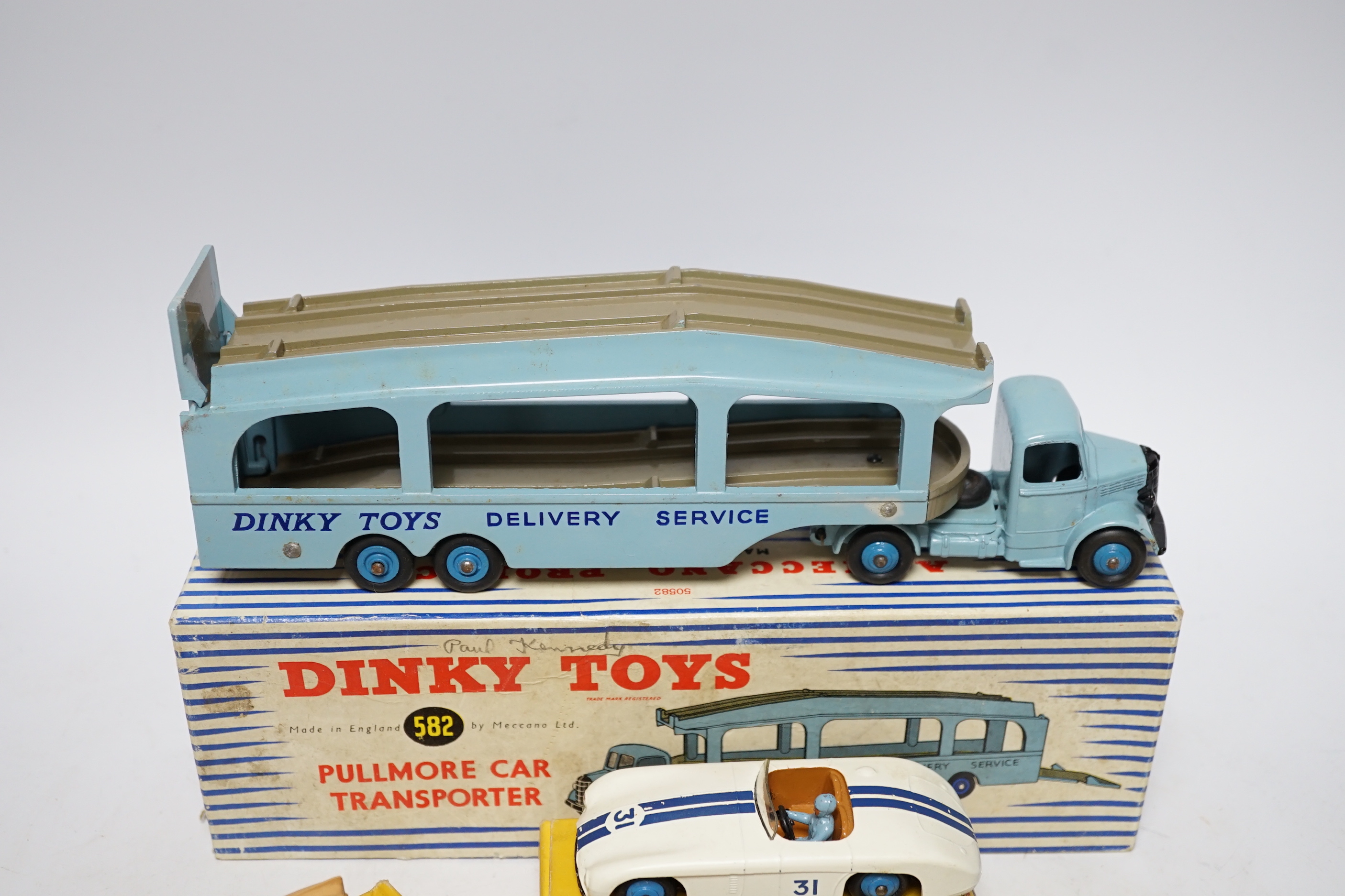 Five boxed Dinky Toys; (132) a Packard Convertible, (131) a Cadillac Tourer, (133) a Cunningham C-5R road racer, (157) a Jaguar XK120 and (582) a Pullmore Car Transporter with a (994) Loading Ramp, together with a Cresce